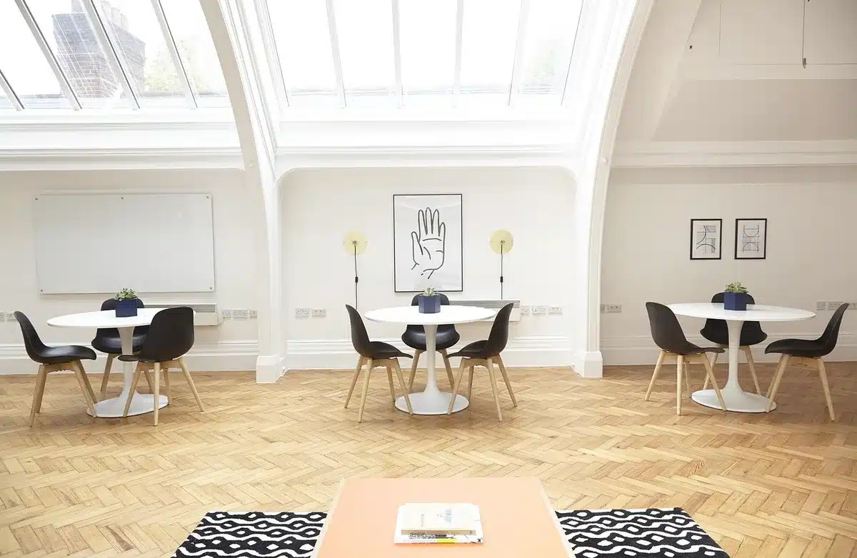 Dining room with muted blue walls, skylight and dark beams