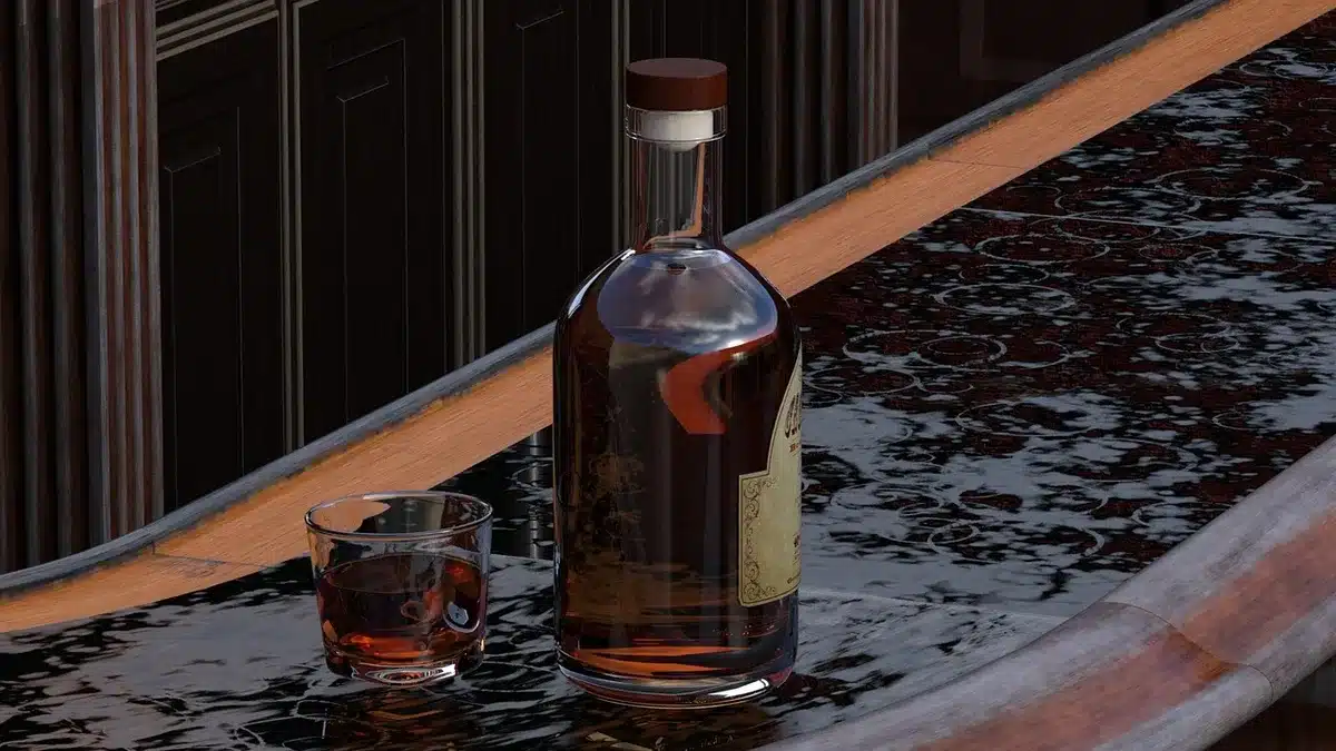 Close-up of a bourbon glass with droplets of water and visible amber color