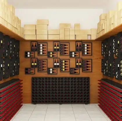 Amber whisky bottles displayed on wooden shelves in a dimly lit distillery setting