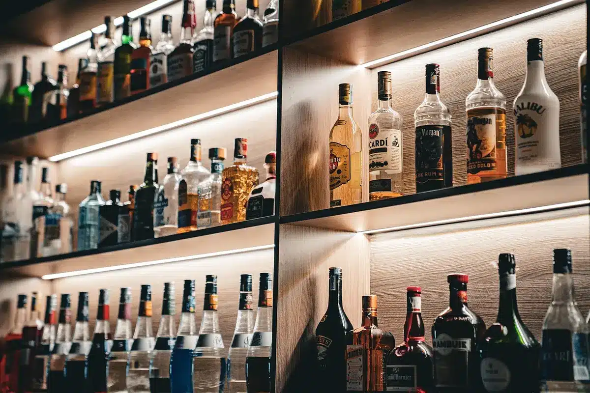 Bartender preparing a cocktail with fresh ingredients at a bar counter