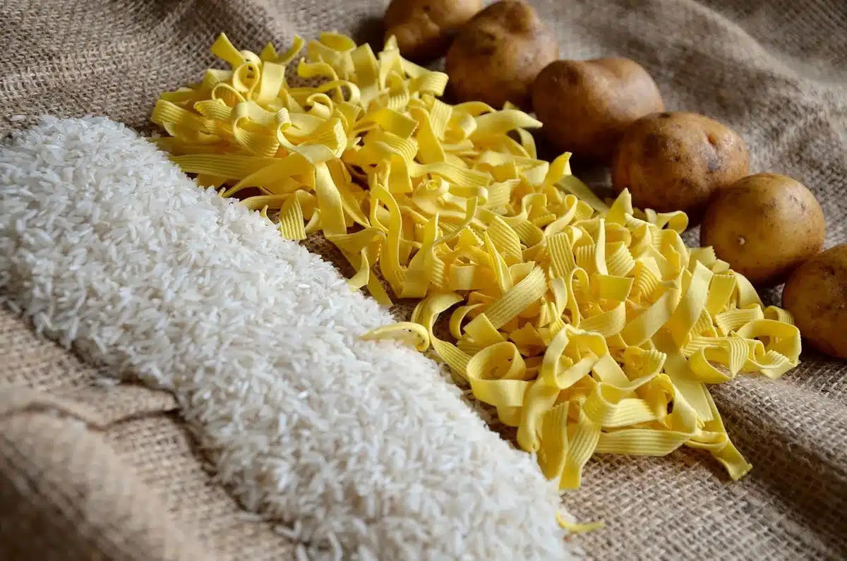 Baking essentials arranged on a counter: flour, sugar, butter, eggs, and baking powder