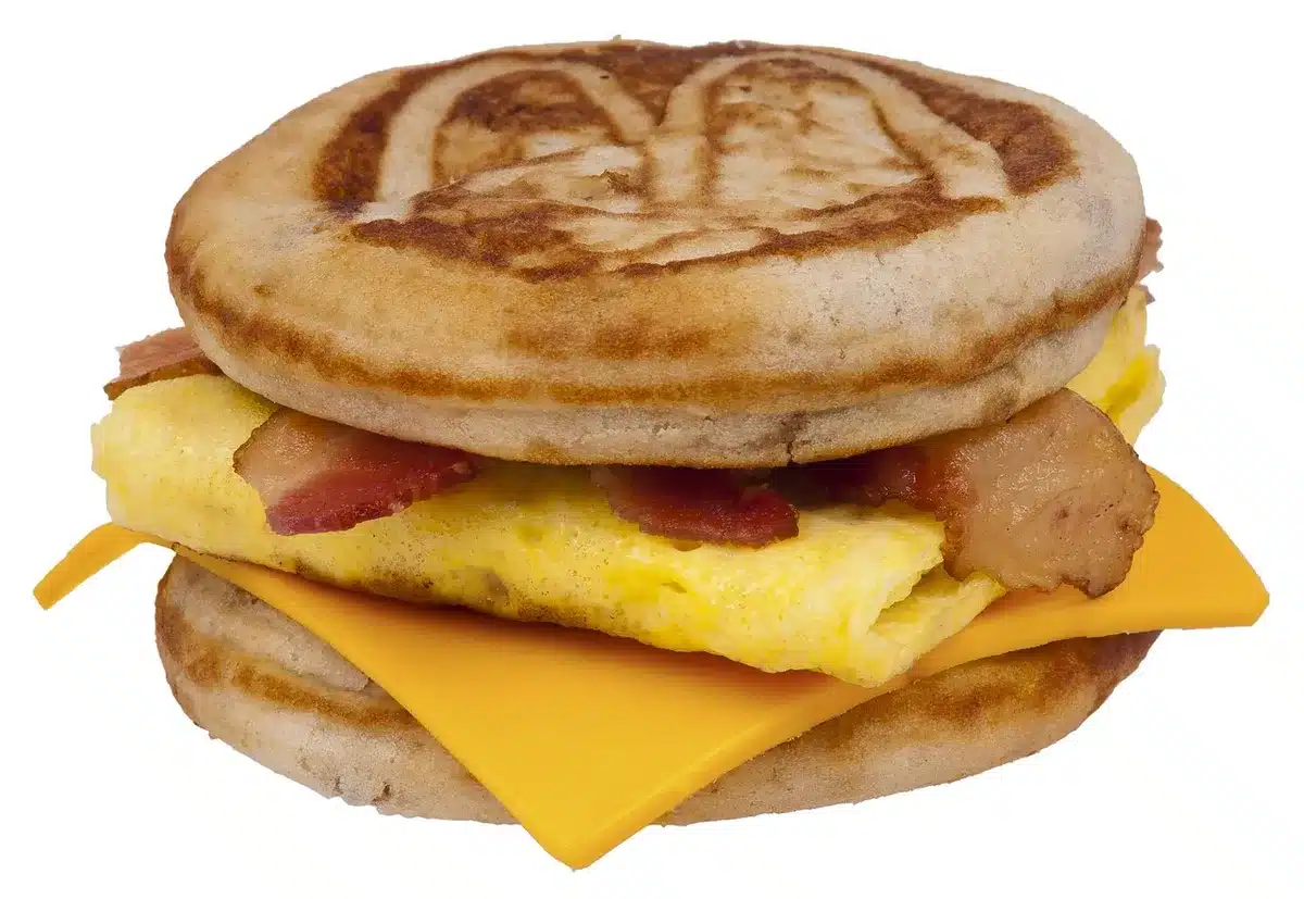 Variety of frozen breakfast items including stacked pancakes, egg muffins, and wrapped breakfast burritos