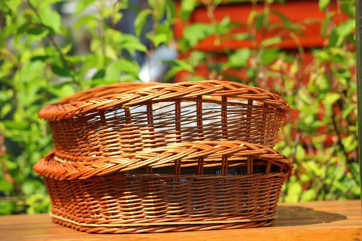 Fryer basket with French fries being shaken and drained