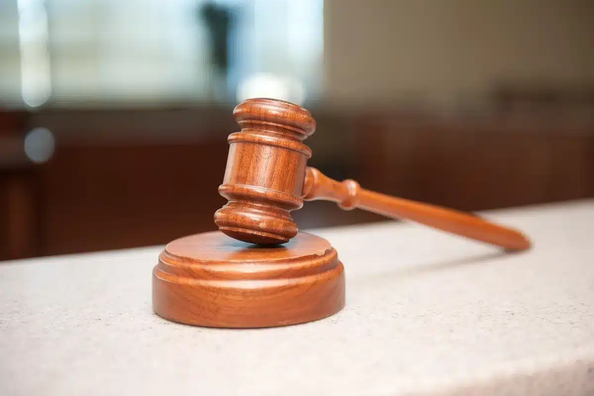 Gavel and legal documents on a courtroom table representing bond and hearings