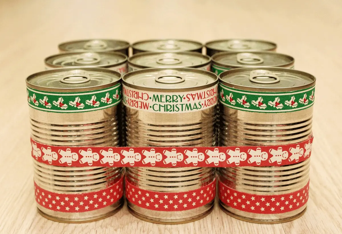 Canned black beans, hominy and dried chilies on a pantry shelf