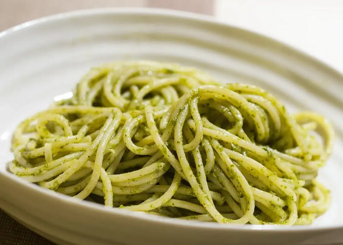 A bowl of spaghetti with tuna, lemon zest, and fresh herbs dressed in olive oil.