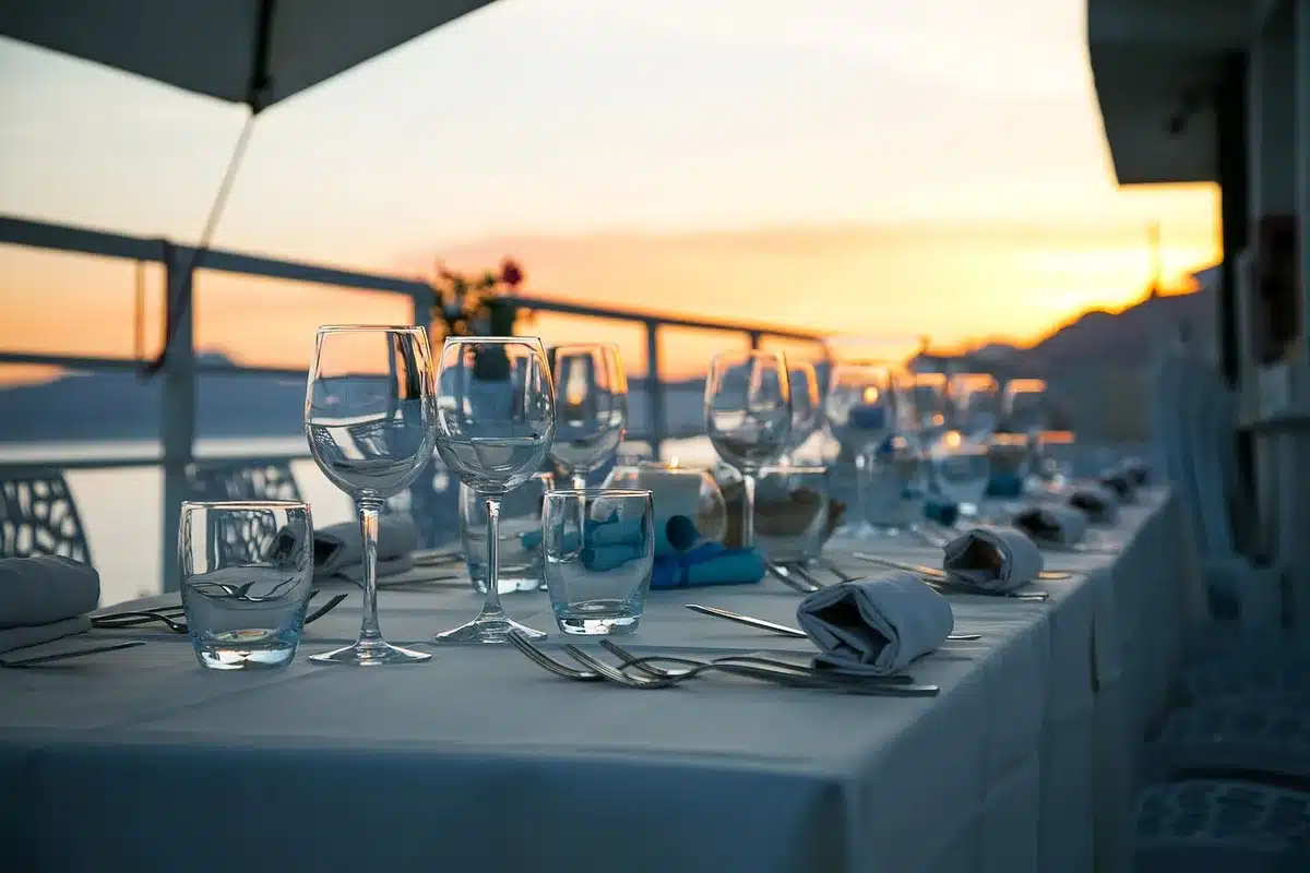 Waiter offering water selection to diners at a restaurant table