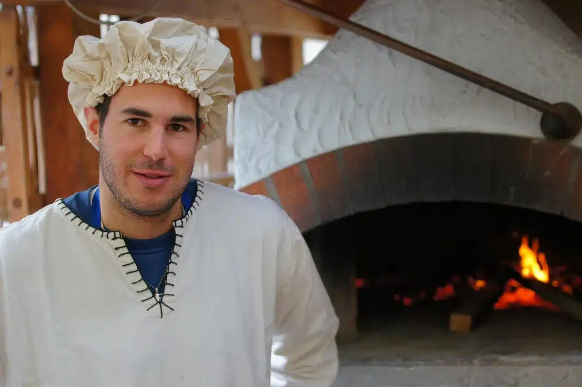 Wood-fired pizza oven with plant-based toppings on personal pizzas