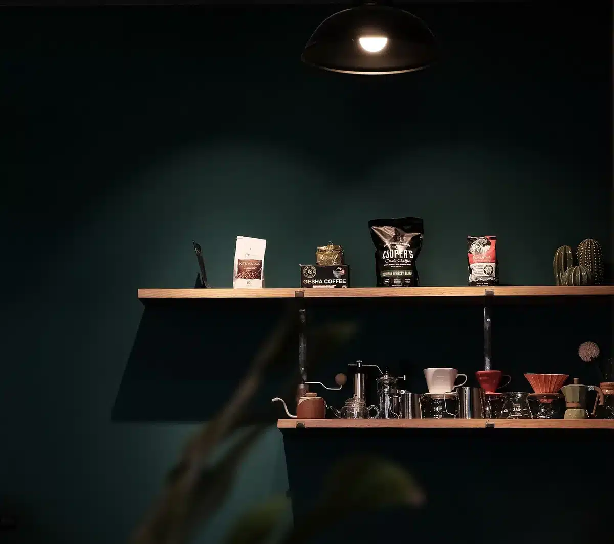 Faded vintage coffee cans on an antique shop shelf with a hand reaching for one