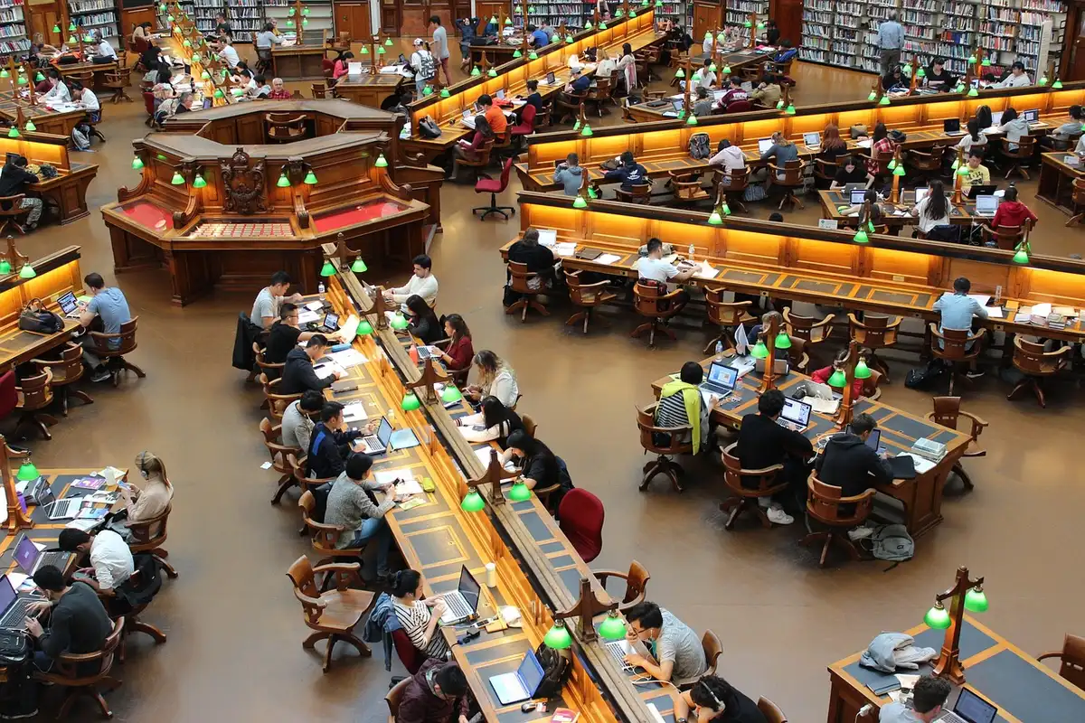 Silhouetted researchers around a table with laptops and papers