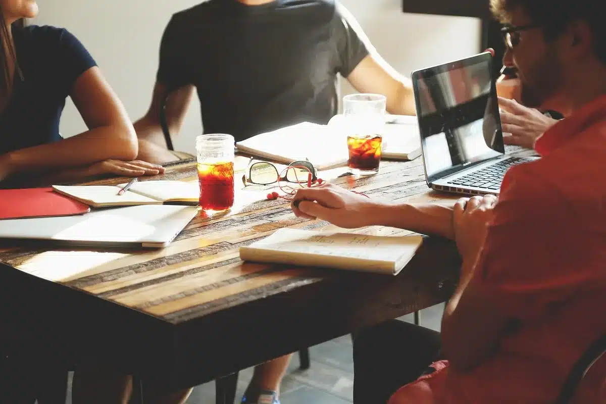 Hands over public-health reports beside a laptop in a bright meeting room