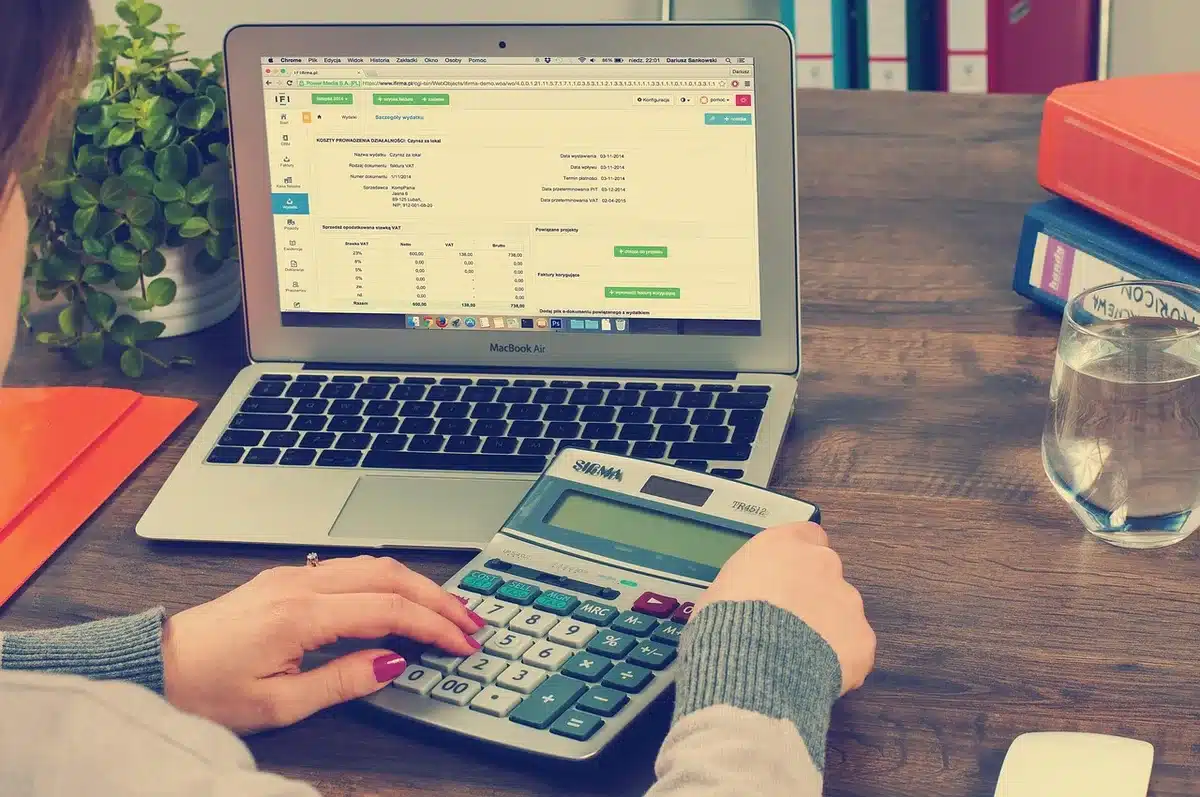 Person reviewing payroll statistics on a laptop with charts