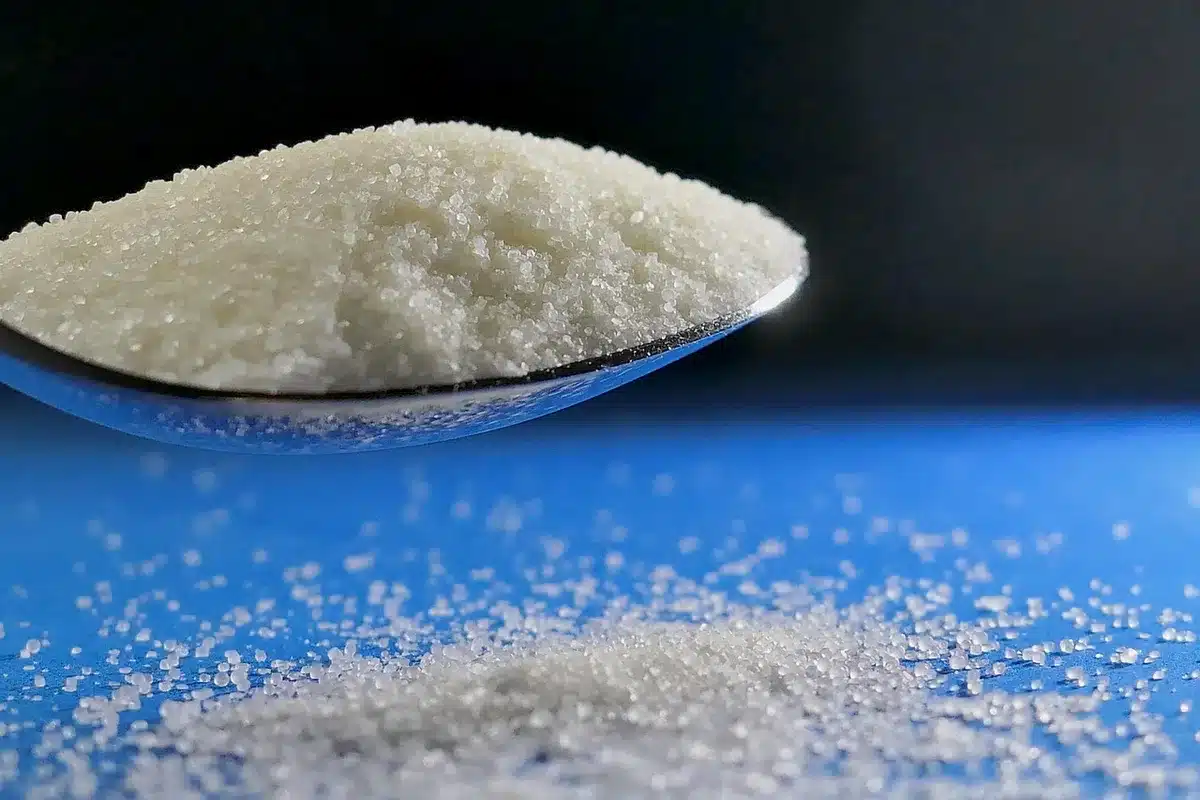 Small pinch of salt being sprinkled into a beer glass