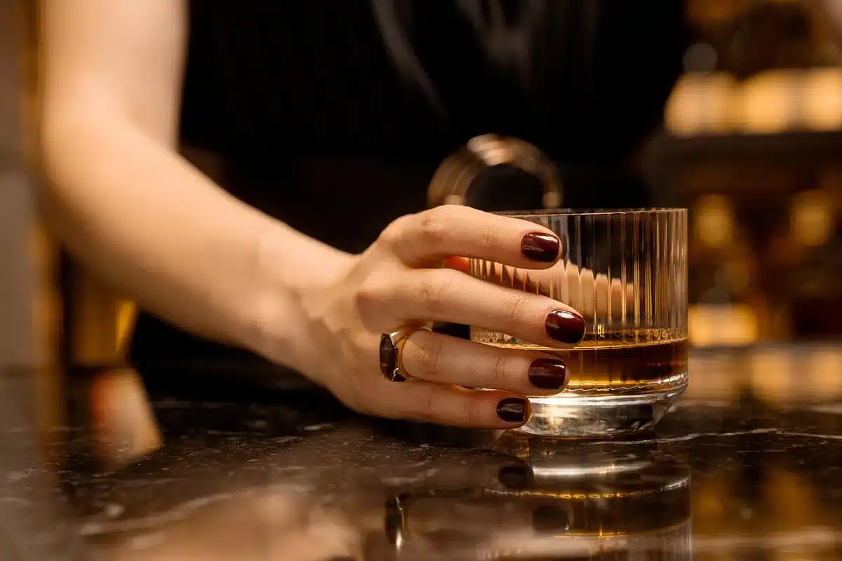 Autumn cocktail on a bar with apple garnish and warm spices